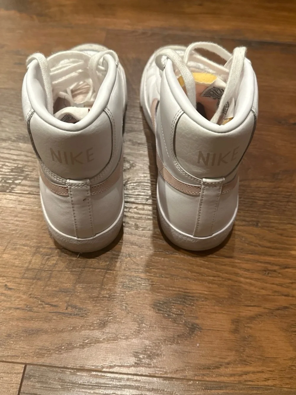 Nike Women's White High-Top Sneakers with Pink Swoosh Accent